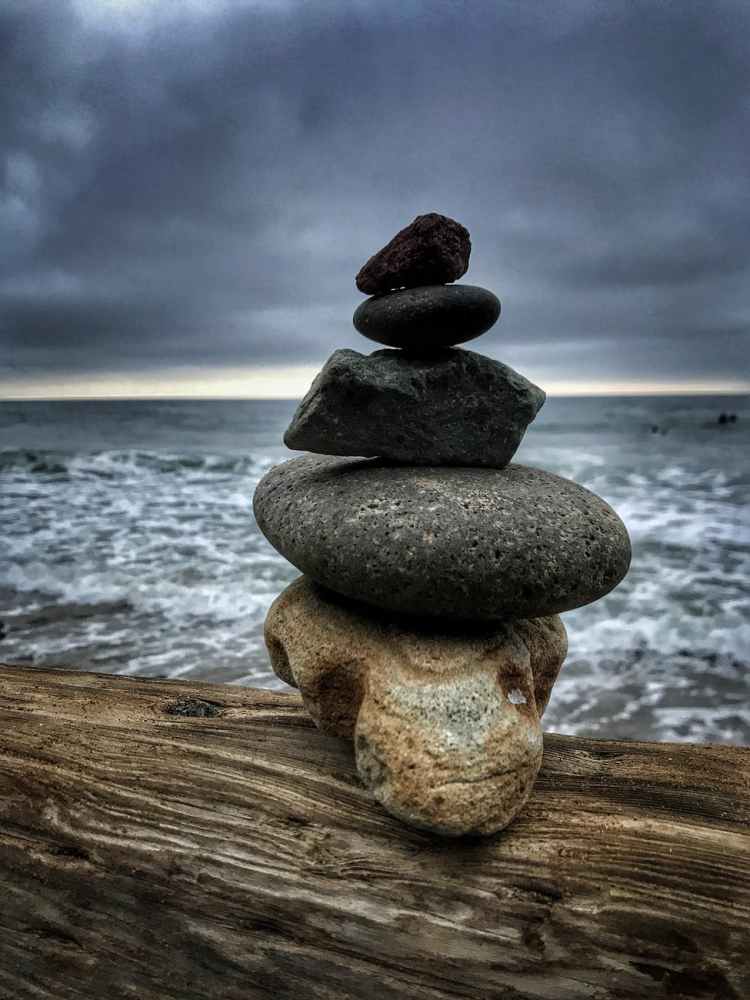 balance beach boulder close up